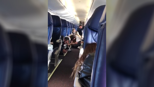 Flyers Crouch Below Seats, Child Cries As Gunfire Rages Outside